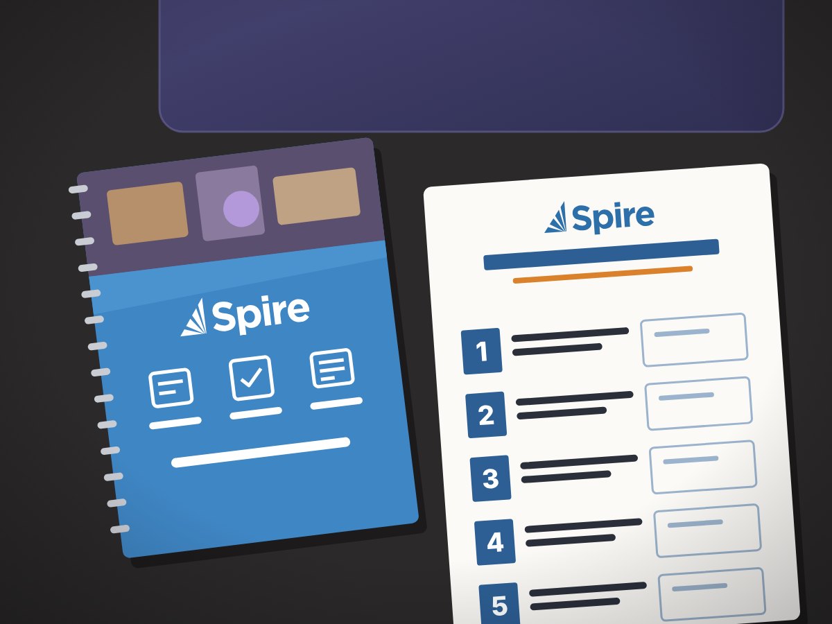 Illustration of a Spire notebook and the Spire Exhibitor Engagement Card on our table.
